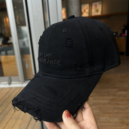 A black distressed cotton baseball cap with embroidered lettering and frayed brim details.
